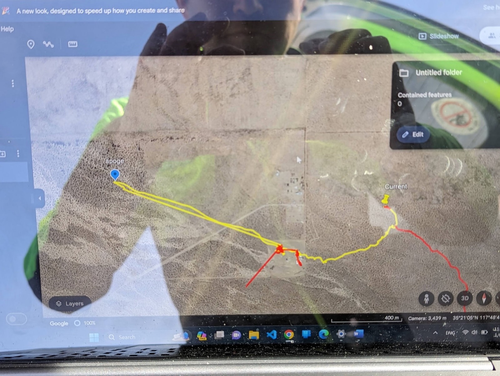 Laptop showing the flight path in Google Earth, with the apogee point marked and the descent track running back toward the pad.